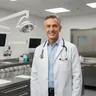 Internal medicine physician in white coat smiling